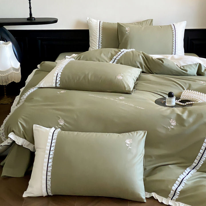 Cotton satin bed linen set with delicate rose embroidery, ruffled edge and contrasting reversible look