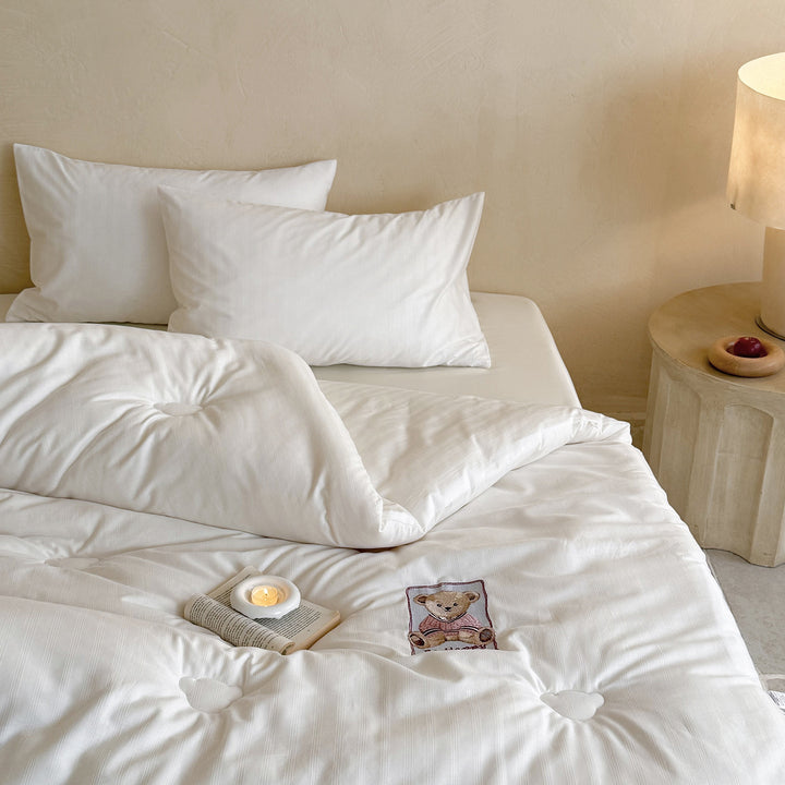 Quilted duvet with teddy applique and breathable microfiber filling