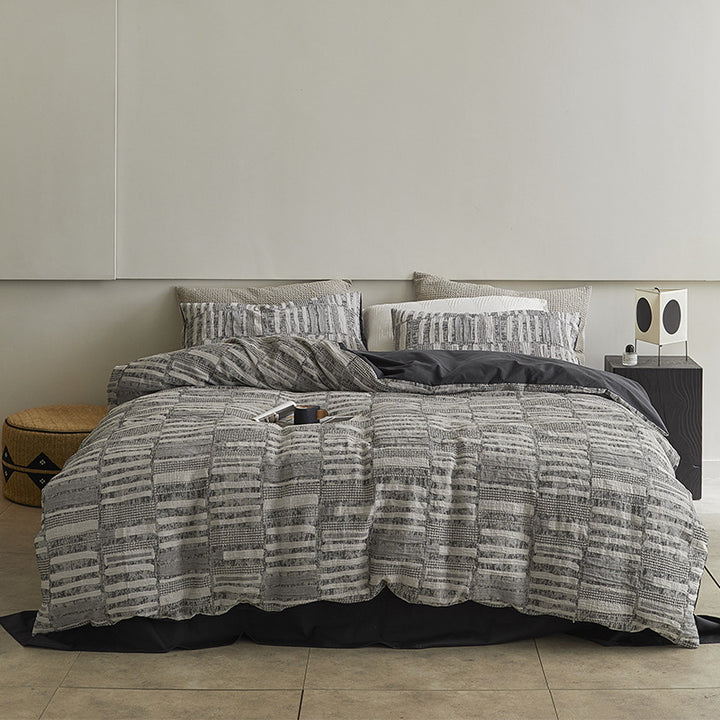 Quilted bed set with textured jacquard stripe design