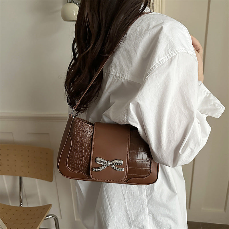 Elegant Crocodile-Patterned Handbag with Bow Detail