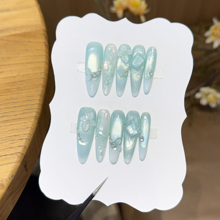 Artificial nails with floral designs and glitter effects Stornfield