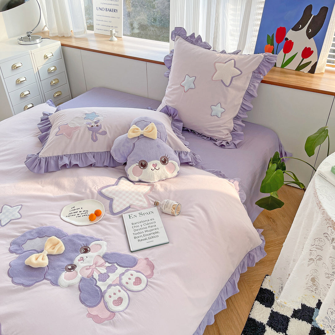 Children's bedding set with plush appliqués, ruffled flounces, and embroidery