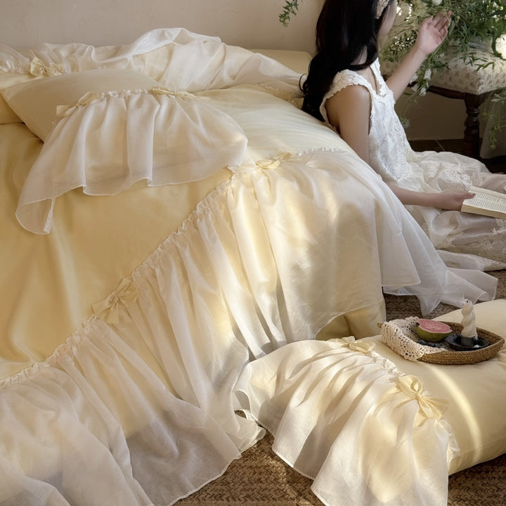 Bedding set with ruffled bed skirt, ruffle cushion and bow application