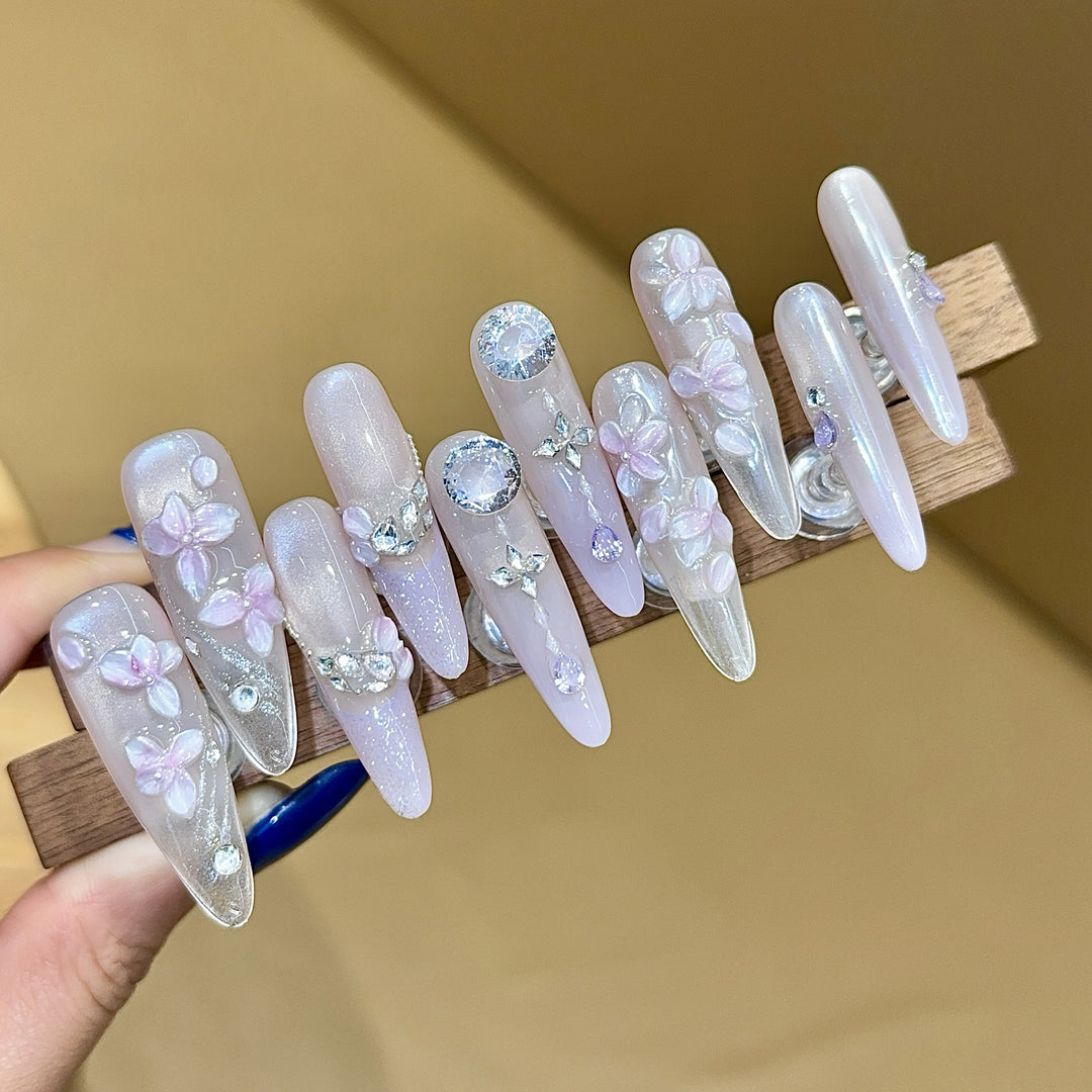 Artificial nails with delicate flower design and glitter accents Stornfield