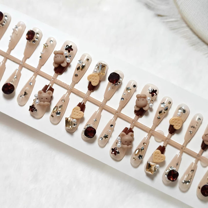 Creative acrylic nails with animal motifs and glitter accents Stornfield