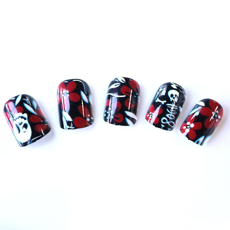 Artificial nail set with creepy skull design and floral accents Stornfield