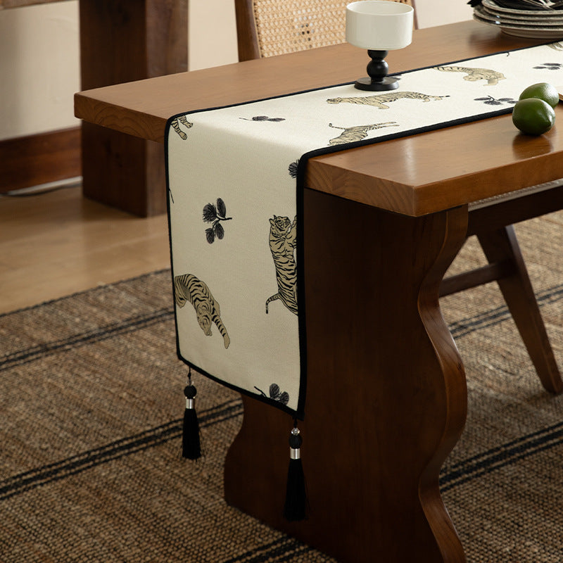 Woven cotton-linen table runner with tiger print and decorative tassels