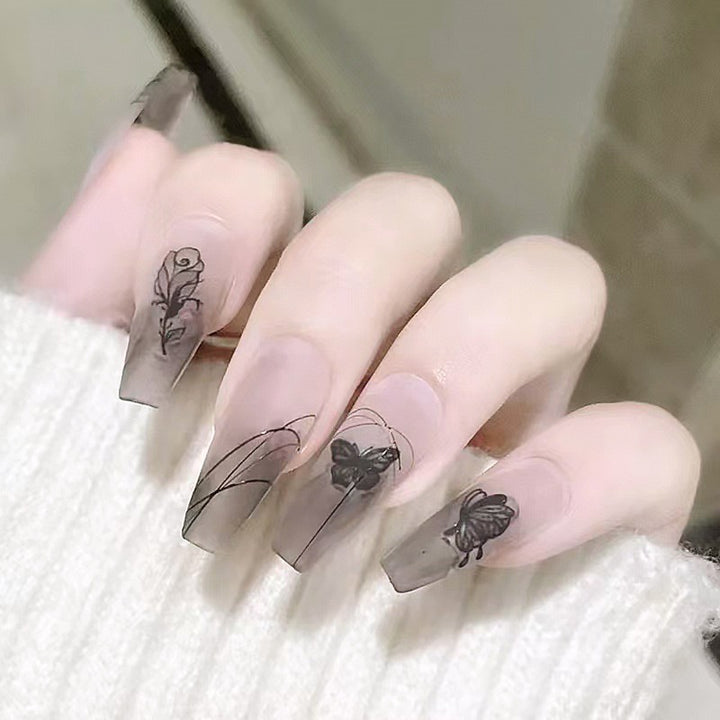 Artificial nail set with elegant flower design and delicate butterfly motifs Stornfield