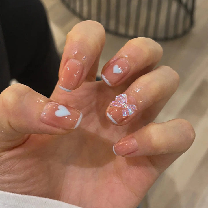 Nail art with heart and butterfly motifs Stornfield