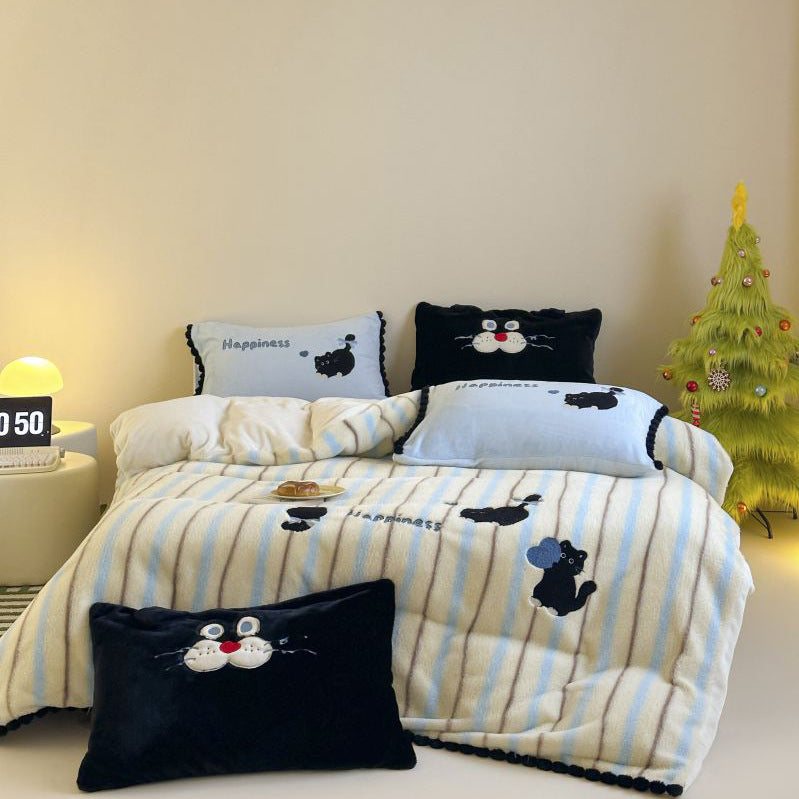Cozy bedding and cuddly blanket set with embroidered cat appliqués