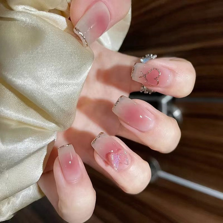Artistic acrylic nails with heart and butterfly motifs Stornfield