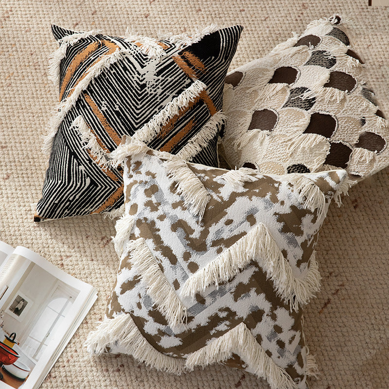 Woven square decorative cushion with fringe application and geometric pattern