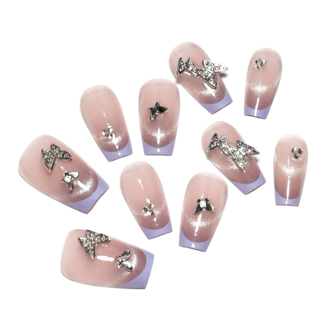 Artificial nail extensions with glitter design and elegant accents Stornfield