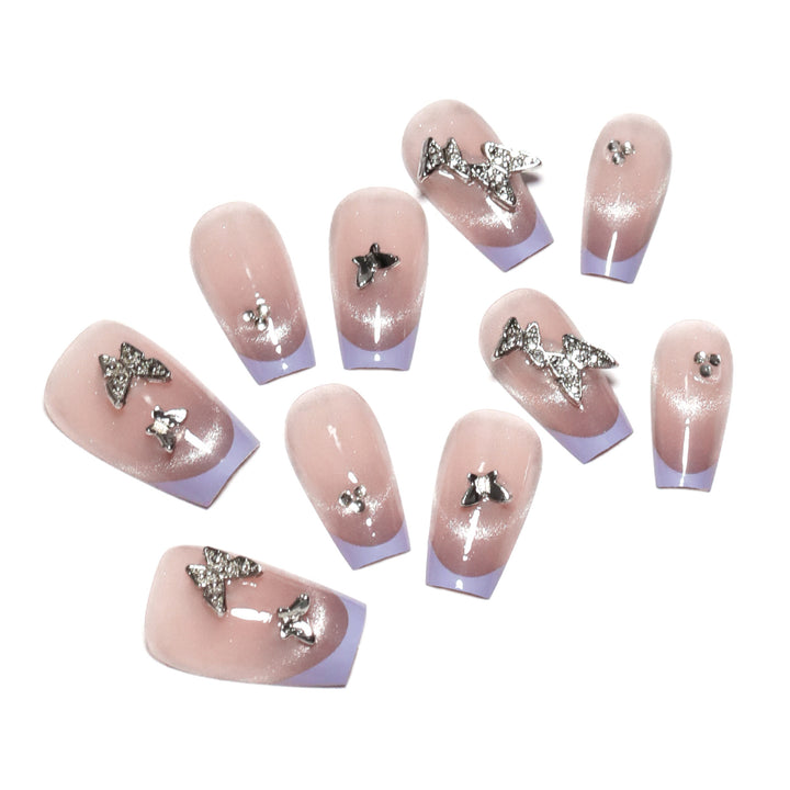 Artificial nail extensions with glitter design and elegant accents Stornfield