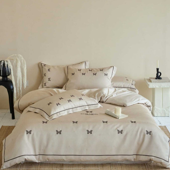 Cotton satin bed linen set with fine butterfly embroidery and piping detail