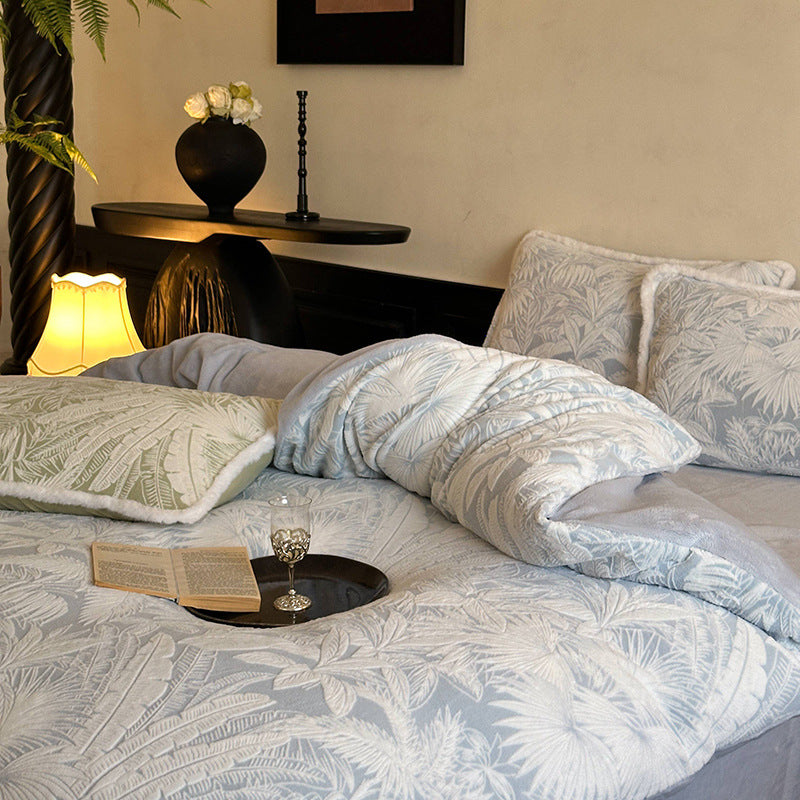 Quilted bed set with jacquard palm pattern and reversible comfort side