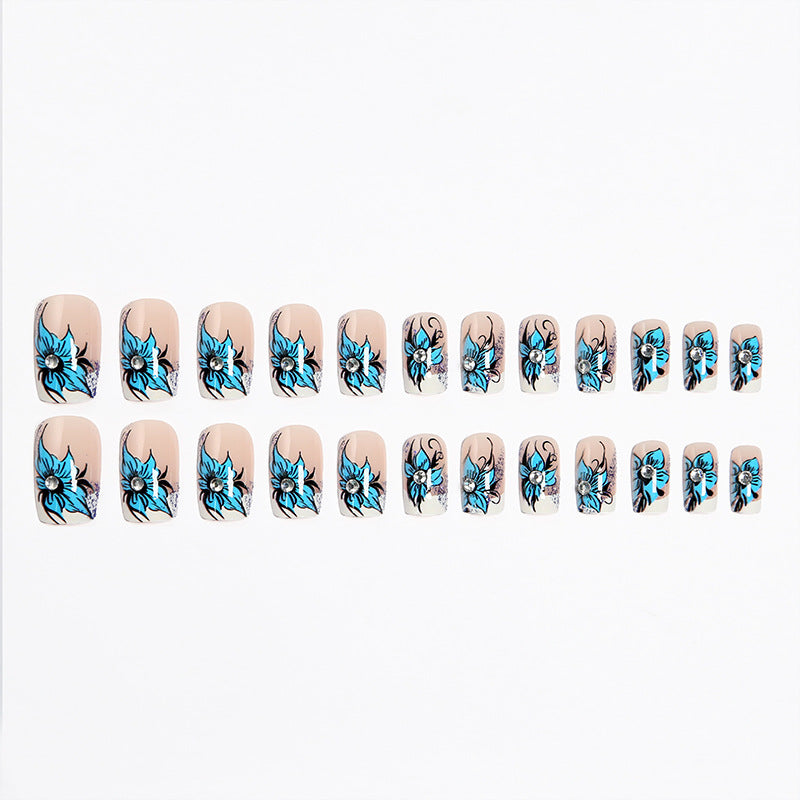 Artificial nail set with intricate floral designs and glitter elements Stornfield