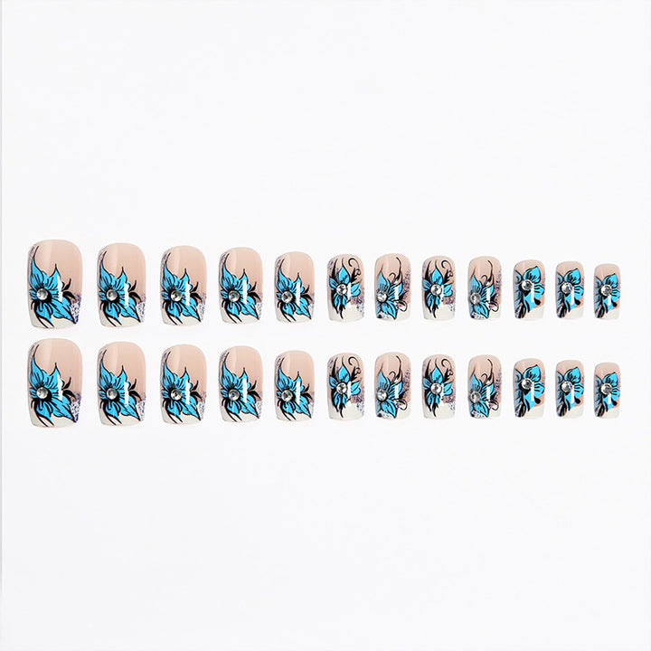 Artificial nail set with intricate floral designs and glitter elements Stornfield