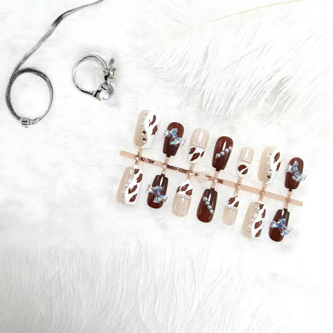 Artificial nails with sparkling rhinestone and bow accents Stornfield