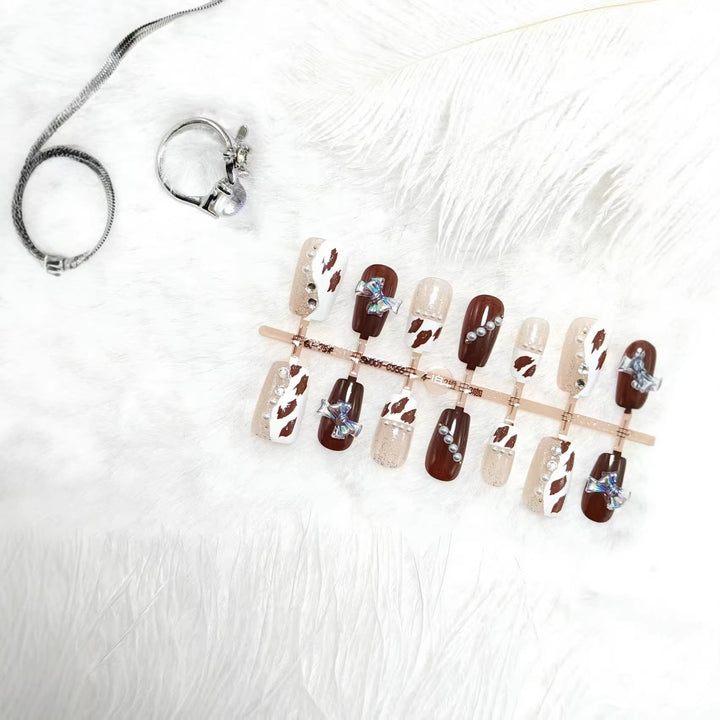 Artificial nails with sparkling rhinestone and bow accents Stornfield