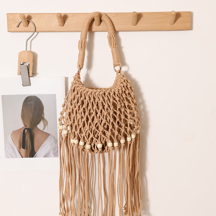 Macrame bag with decorative fringes and wooden beads Stornfield