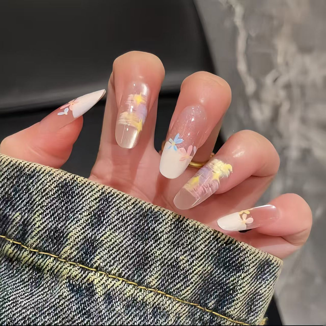 Artificial nails with delicate floral accents and glitter effects Stornfield