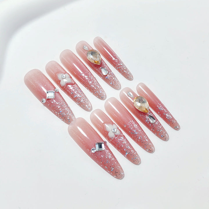 Shiny artificial nails with rhinestones and glitter Stornfield