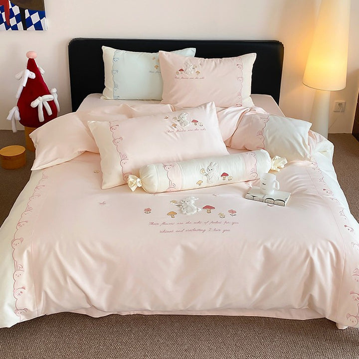 Playful cotton bedding set with plush bunny appliqué and round cushion