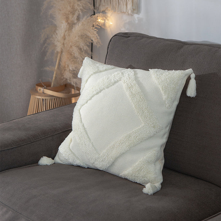Square decorative cushion cover made of cotton bouclé with raised diamond pattern and corner tassels