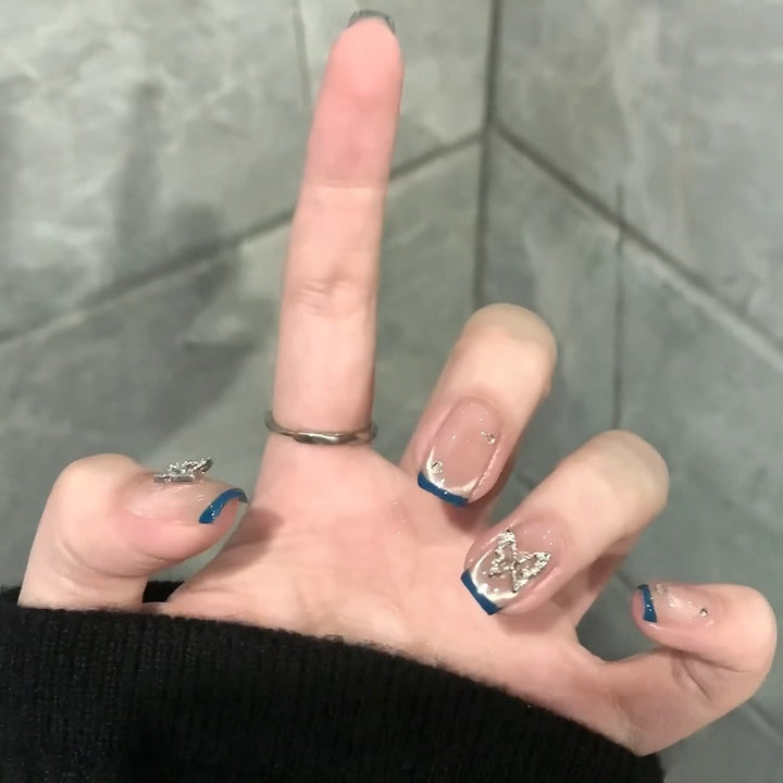 Artificial nails with trendy French tips and decorative glitter accents Stornfield