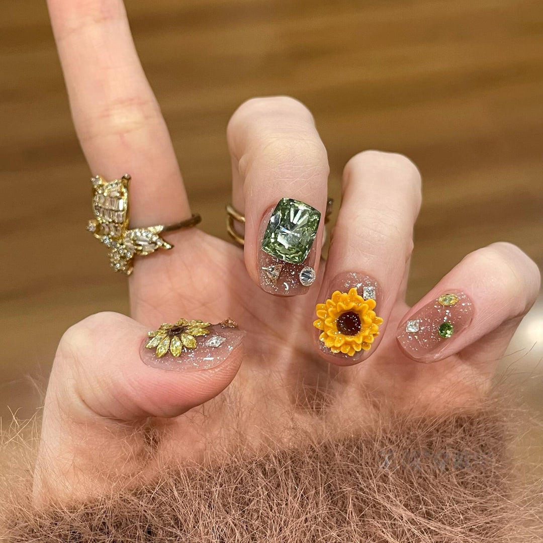 Artificial nails with sparkling appliqués and floral designs Stornfield