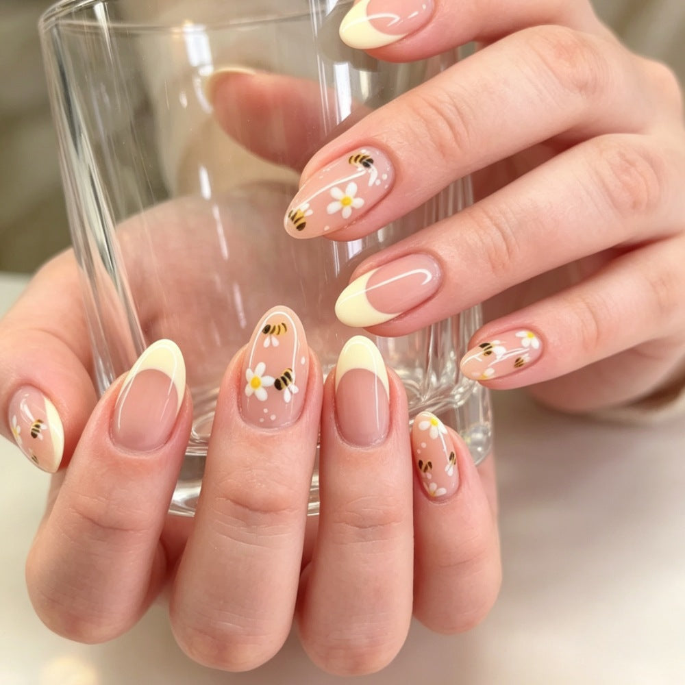 Artificial nails with elegant French tip and floral accents Stornfield