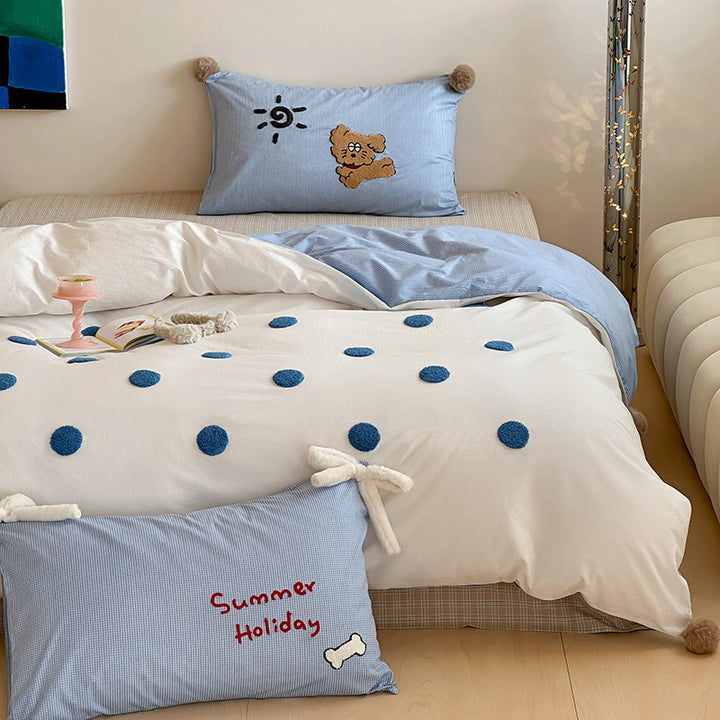 Children's bedding set with striped duvet cover, checkered decorative pillow, and plush application