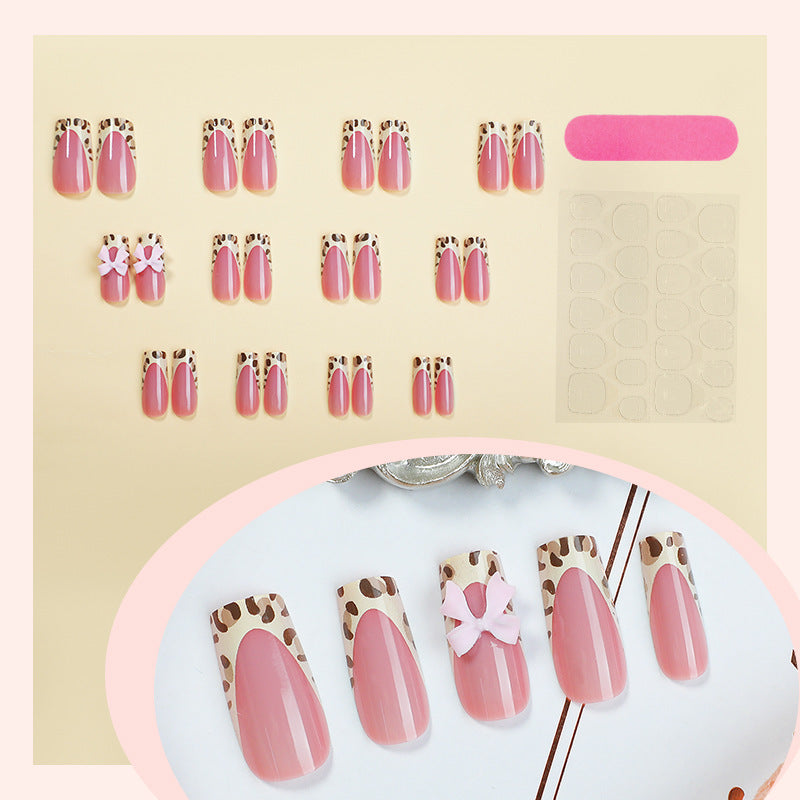 Nail set with elegant leopard accents and bow embellishments Stornfield