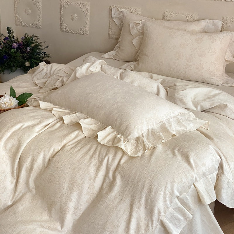 Jacquard bedding set with decorative ruffle border and floral relief