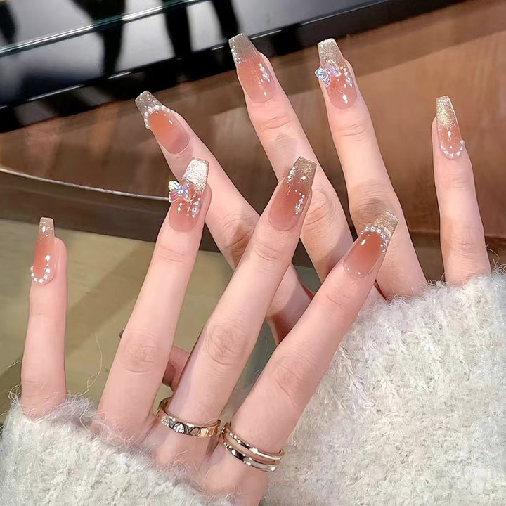 Glamorous artificial nails with elegant bow and butterfly design Stornfield