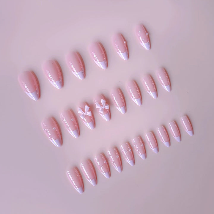 Artificial nail set with shimmering 3D bows and elegant pearl accents Stornfield