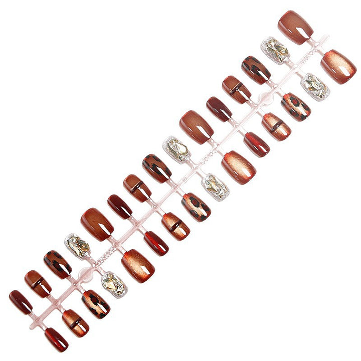 Glamorous artificial nails with animal design and glitter accents Stornfield