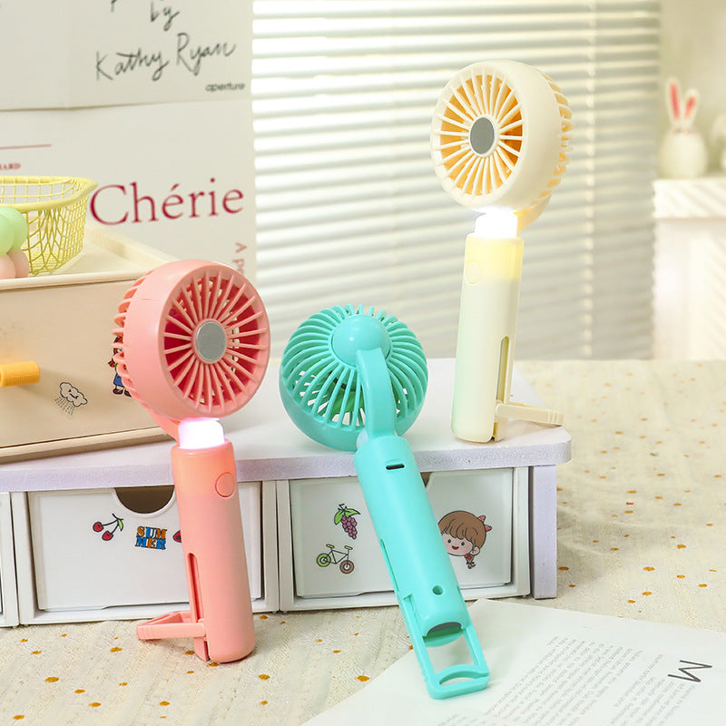 Women portable mini hand fan with integrated LED lighting and USB charging function Stornfield