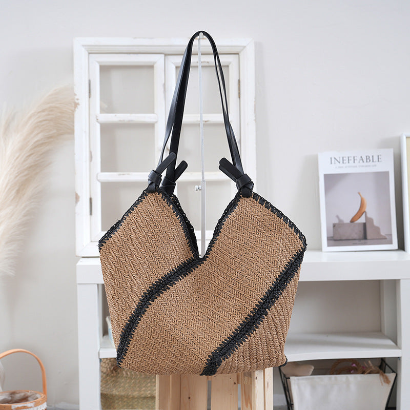 Handbag made of braided natural material with contrasting leather handles Stornfield