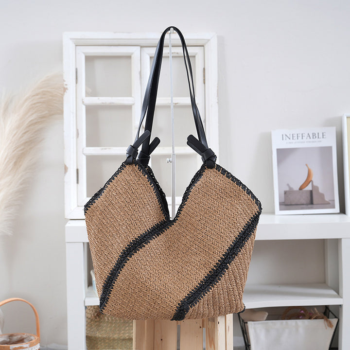 Handbag made of braided natural material with contrasting leather handles Stornfield