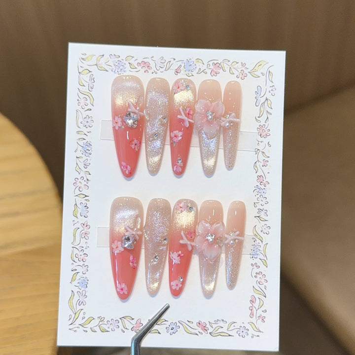 Artificial nails with floral embellishments and glitter effects Stornfield