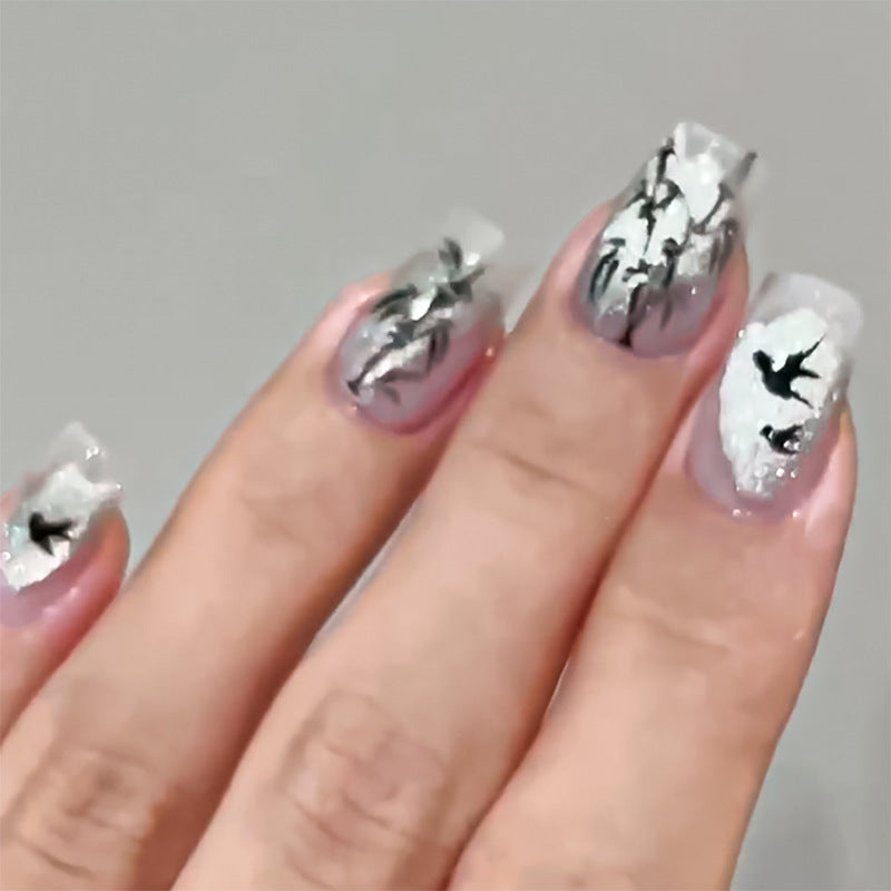 Handcrafted acrylic nails with decorative bird motifs Stornfield
