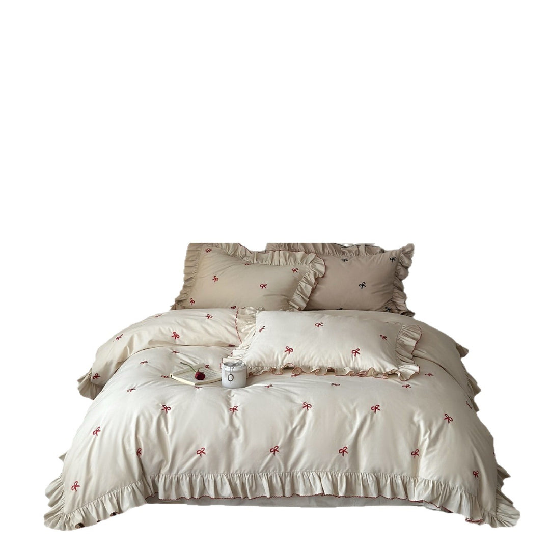 Ruffled bedding set with embroidered bows and frills