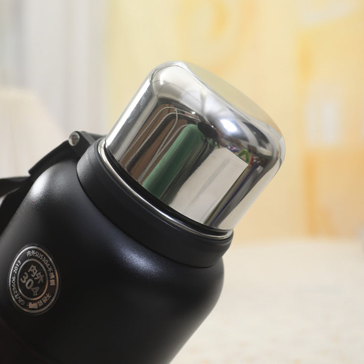 Insulated thermos bottle with practical drinking cup and sturdy carrying strap Stornfield