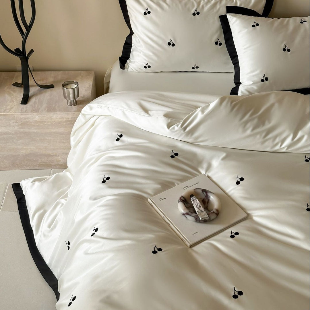 Elegant satin bed set with fine cherry embroidery and contrasting piping