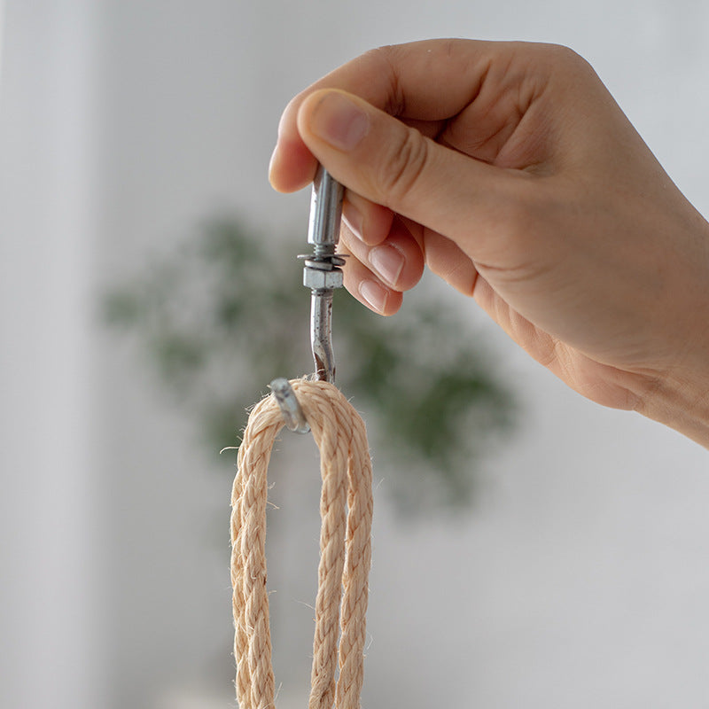Hanging chair made of braided natural material with comfortable cushions Stornfield