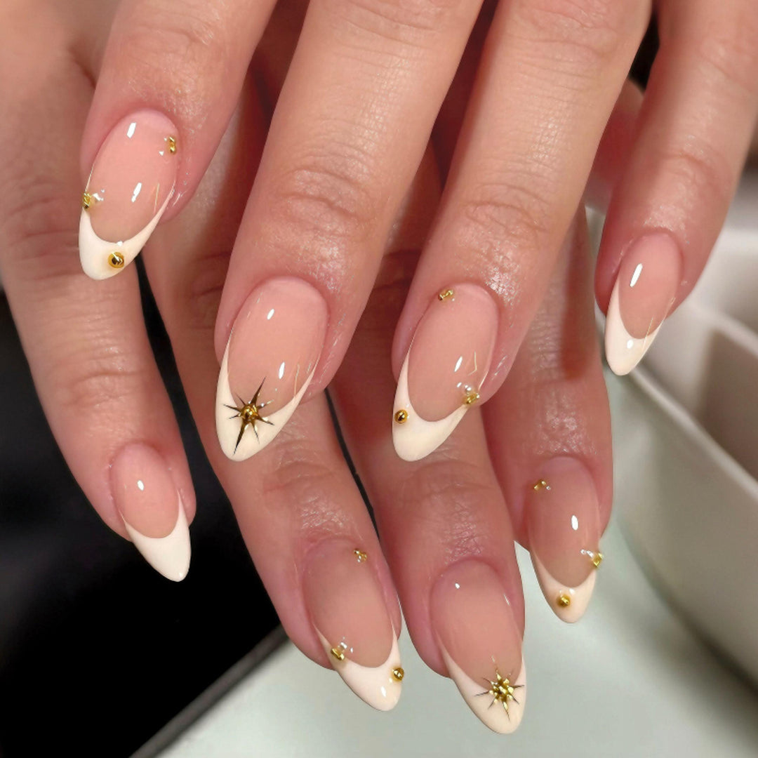Artistic French-tip nail art with glitter and elegant embellishments Stornfield