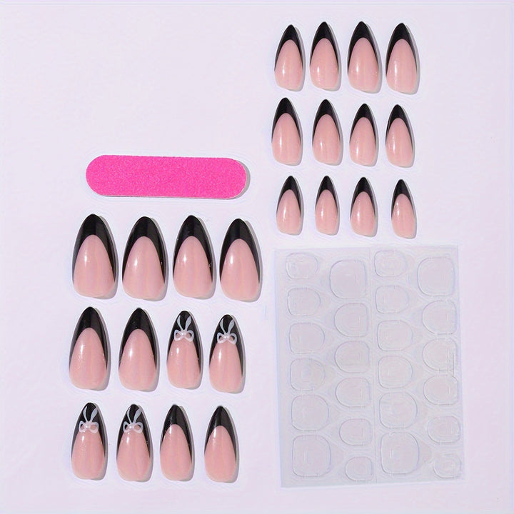 Acrylic nail set with elegant black and white design and cute bow accents Stornfield