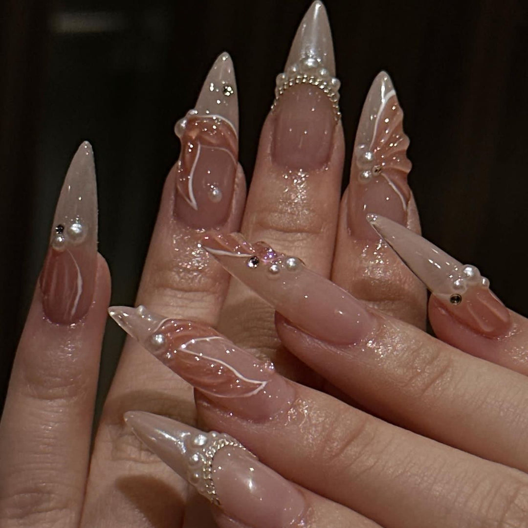 Artistic stiletto nails with pearl and flower embellishments Stornfield